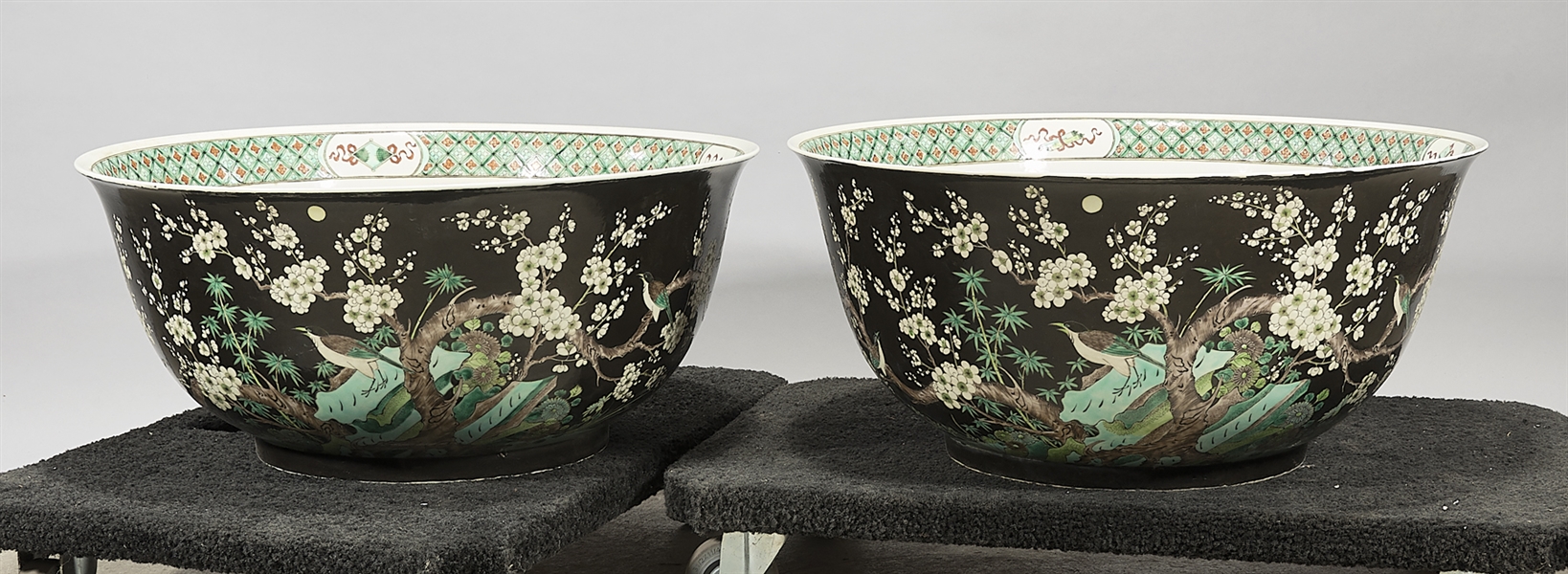 Appraisal: Pair of large Chinese enameled porcelain bowls depicting trees flowers