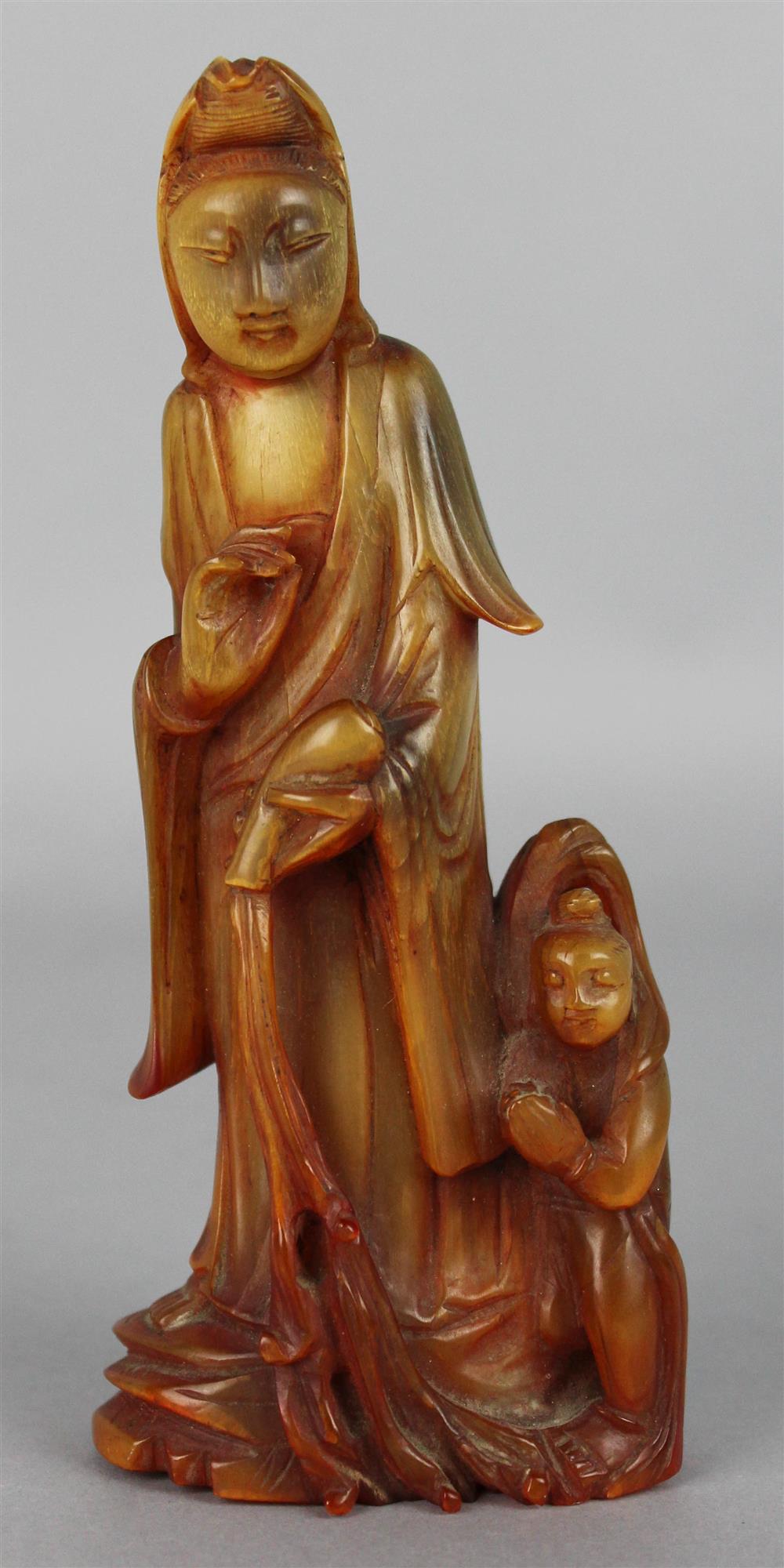 Appraisal: CHINESE HORN FIGURE OF GUANYIN AND A CHILD the deity