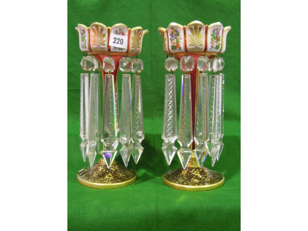 Appraisal: A pair of Victorian cranberry glass table lustres with alternating