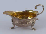 Appraisal: A small Georgian silver cream boat with gilt interior flying