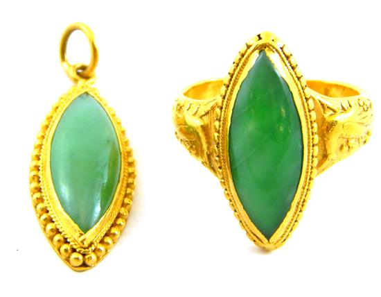 Appraisal: JEWELRY Two jade and gold oval pieces both tested K