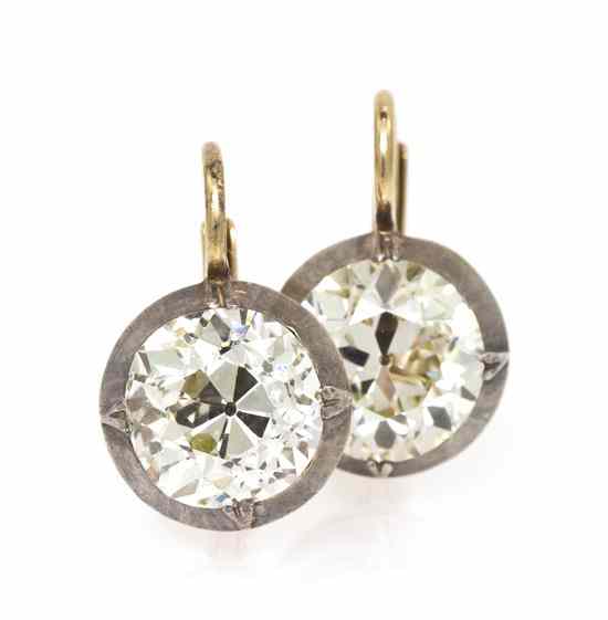 Appraisal: A Pair of Edwardian Gold and Diamond Earrings containing two