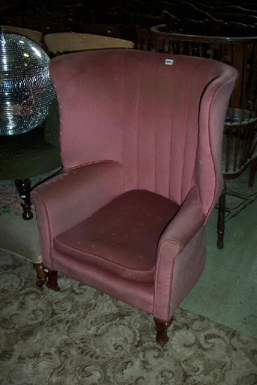 Appraisal: An Edwardian wing back armchair in the Georgian style with