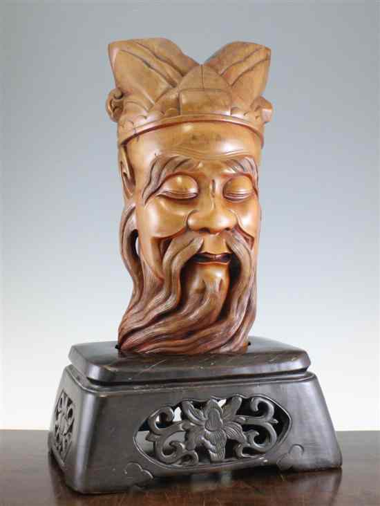 Appraisal: A Chinese carved wood head of an immortal wearing a