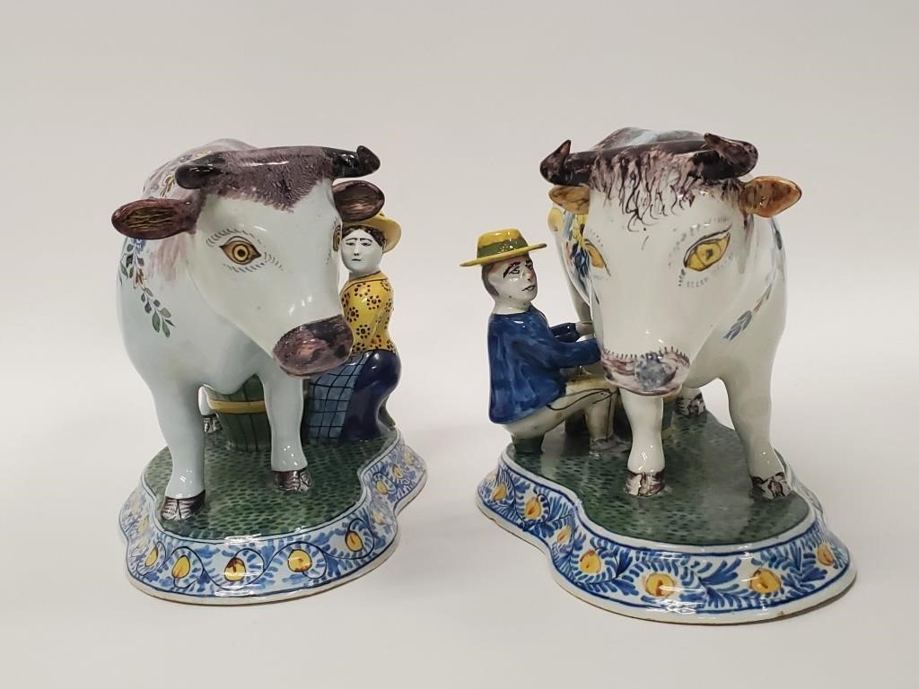 Appraisal: Two Delft polychrome figurines of a man and woman milking