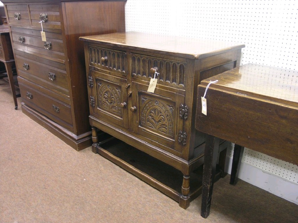 Appraisal: A solid medium oak credence cupboard two drawers with gouged