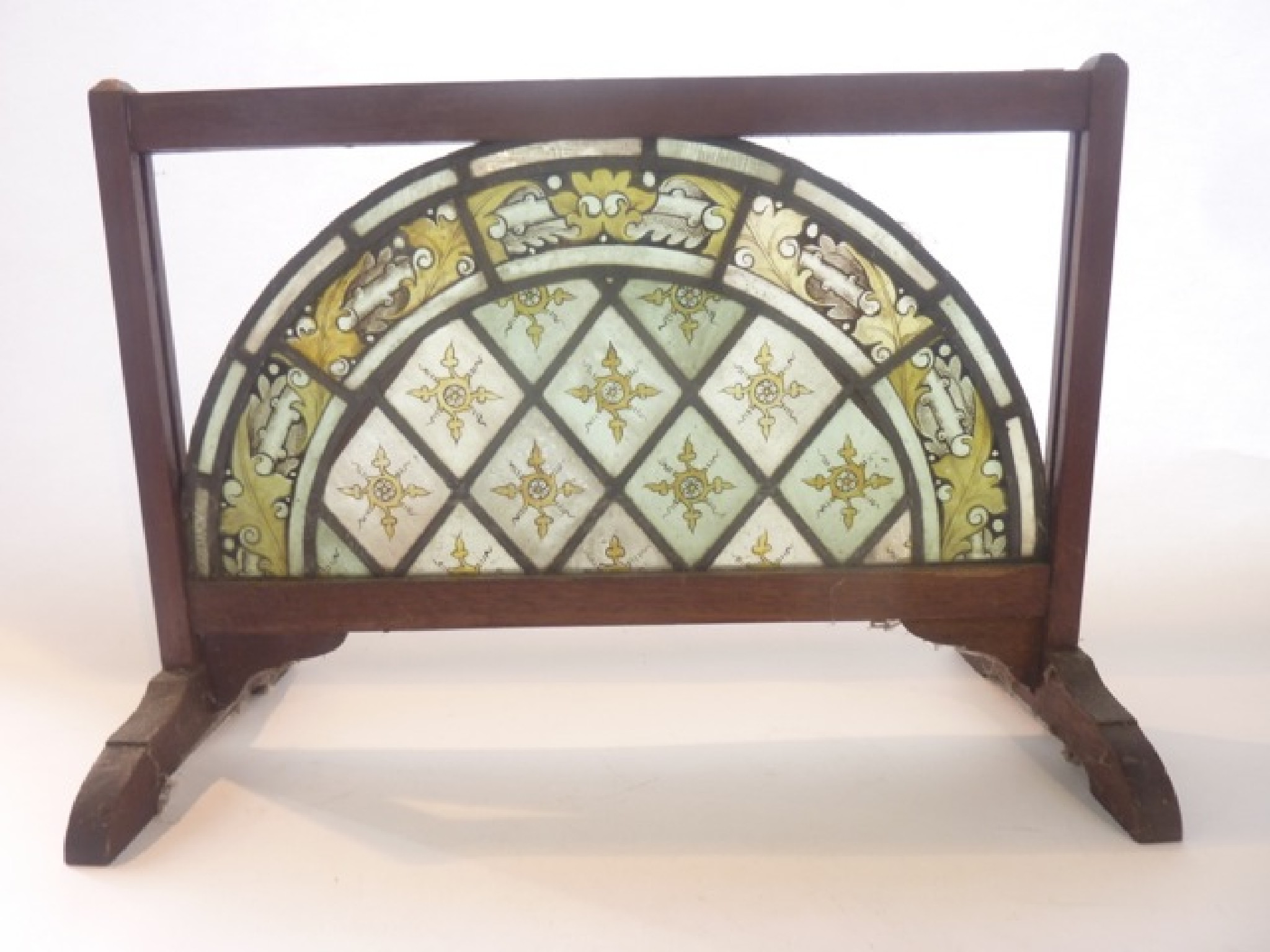 Appraisal: A leaded glass panel of arched form with hand painted