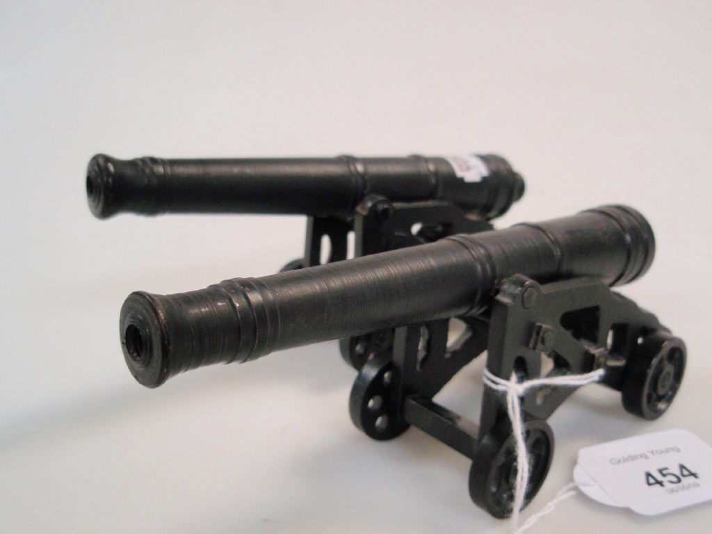 Appraisal: A pair of miniature cannons the bronze barrel cm long