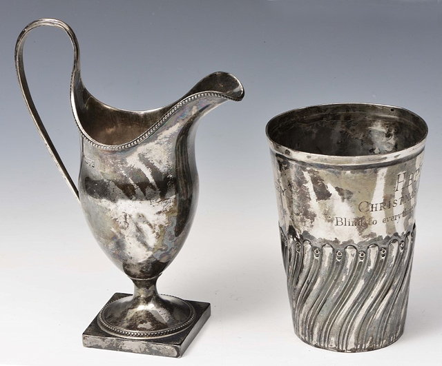 Appraisal: AN EDWARDIAN SILVER HELMET JUG with beaded decoration square foot