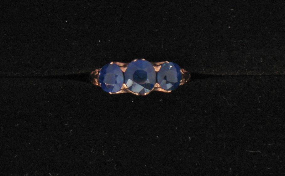 Appraisal: A THREE STONE SAPPHIRE DRESS RING the central round cushion-cut