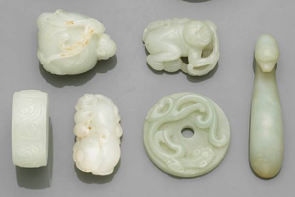 Appraisal: Six nephrite carvings The first depicting a toad climbing over