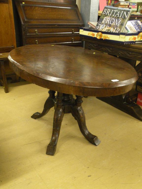 Appraisal: A Victorian walnut oval breakfast table on four turned supports