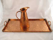 Appraisal: An Arts and Crafts copper two handled tray chased with