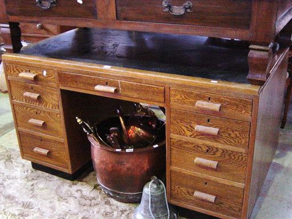 Appraisal: An Art Deco style oak kneehole pedestal desk with inset