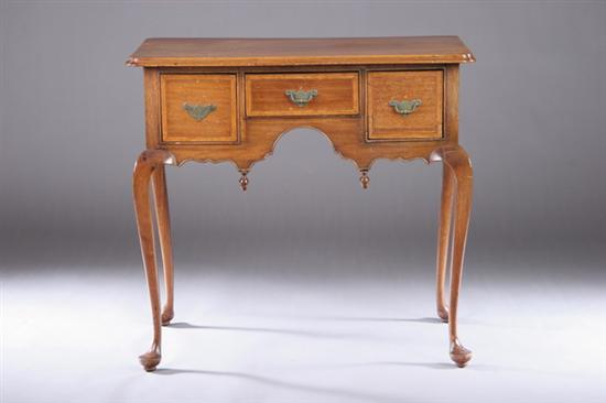 Appraisal: ENGLISH GEORGIAN-STYLE WALNUT DRESSING TABLE Early th century Notched-corner rectangular