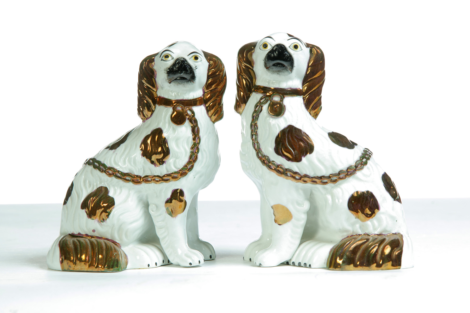 Appraisal: MIRRORED PAIR OF STAFFORDSHIRE SPANIELS England rd quarter- th century