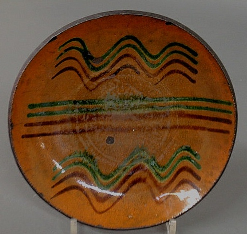 Appraisal: Pennsylvania redware pie plate th c with green and red