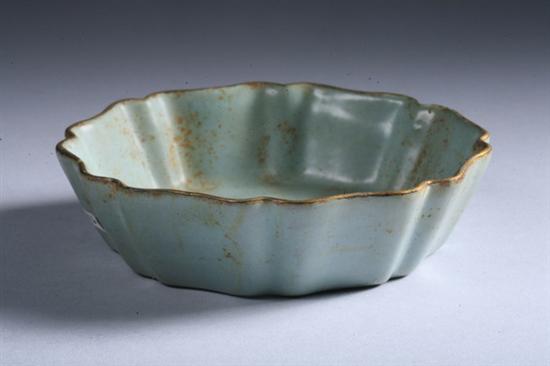 Appraisal: CHINESE CELADON PORCELAIN LOTUS SHALLOW BOWL The foot with gilt