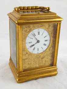 Appraisal: A gilt brass carriage clock with white enamel dial engraved