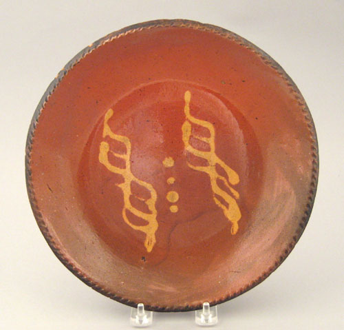 Appraisal: Redware pie plate th c with yellow slip decoration dia