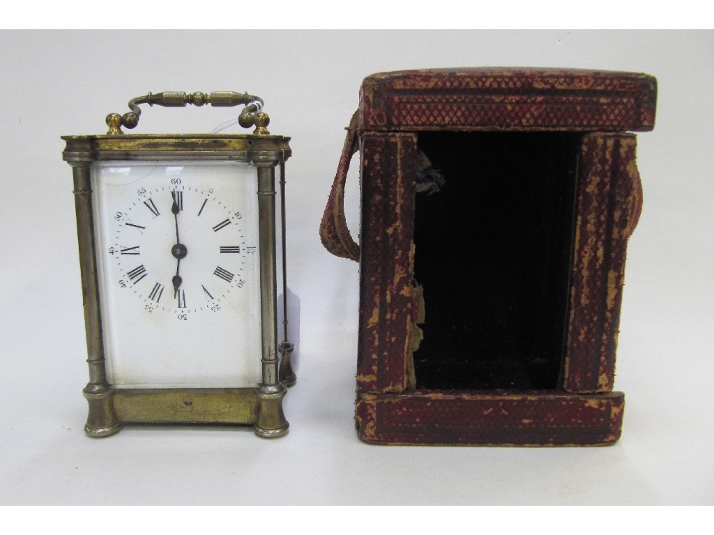 Appraisal: Brass cased carriage clock with white enamel dial and travelling