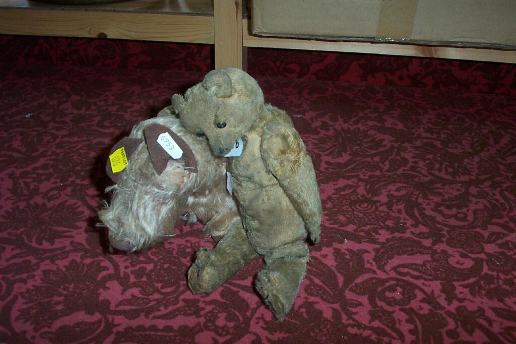 Appraisal: An early th century straw filled teddy much loved together