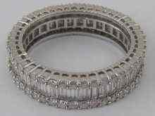 Appraisal: A diamond eternity ring comprising brilliant cut and baguette diamonds