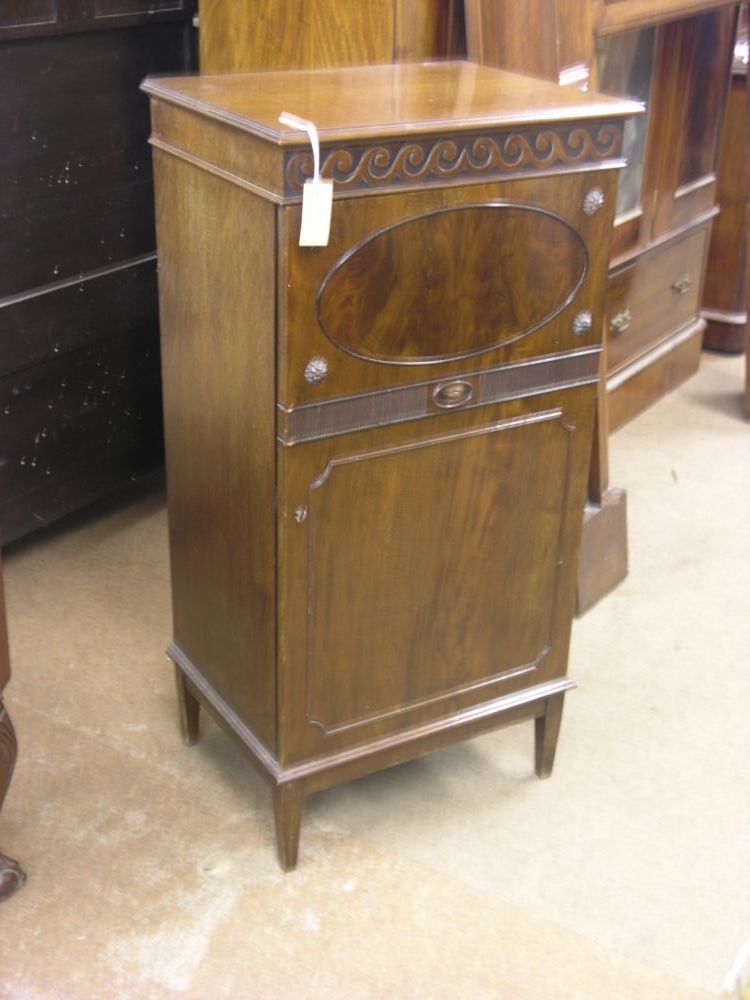 Appraisal: A George V mahogany side cupboard carved with a Vitruvian