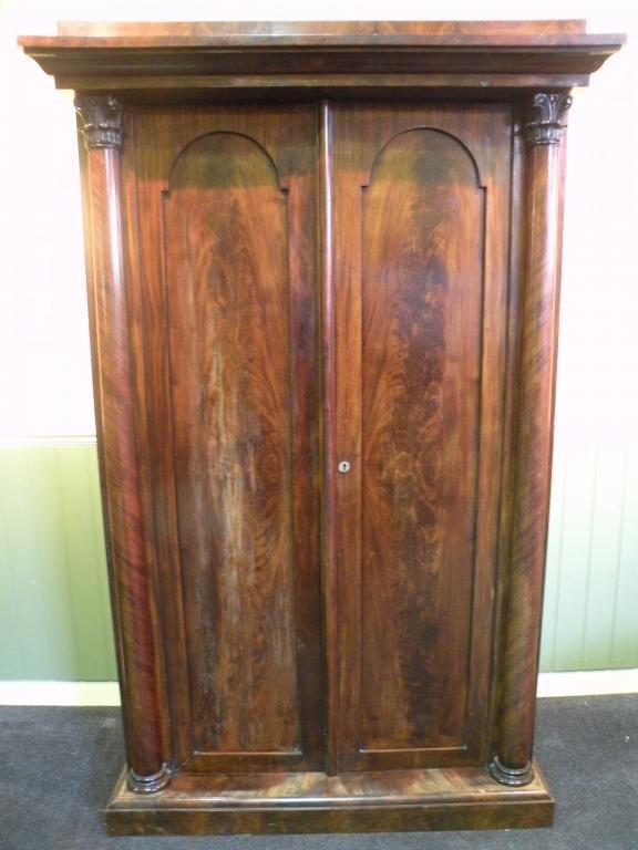 Appraisal: An thC mahogany wardrobe the two doors flanked by cylindrical