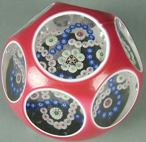 Appraisal: Baccarat red and white overlayed faceted paperweight with interwoven six