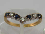 Appraisal: A carat yellow gold sapphire and diamond seven stone wishbone