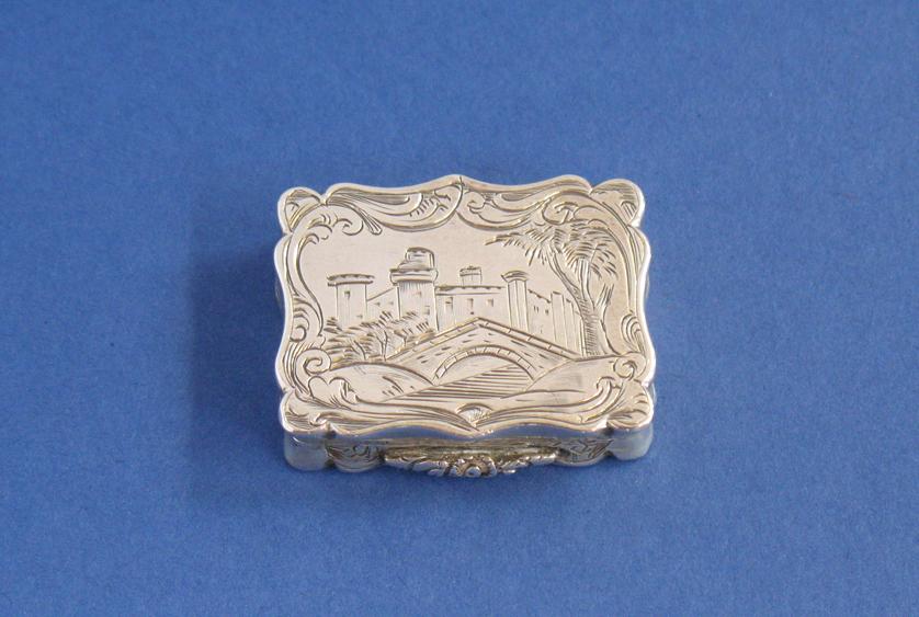 Appraisal: A VICTORIAN ENGRAVED CASTLE TOP VINAIGRETTE of shaped rectangular form