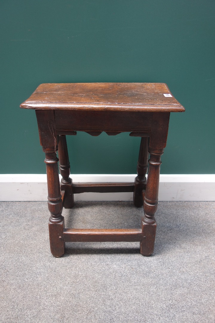 Appraisal: A th century oak joint stool with shaped frieze on