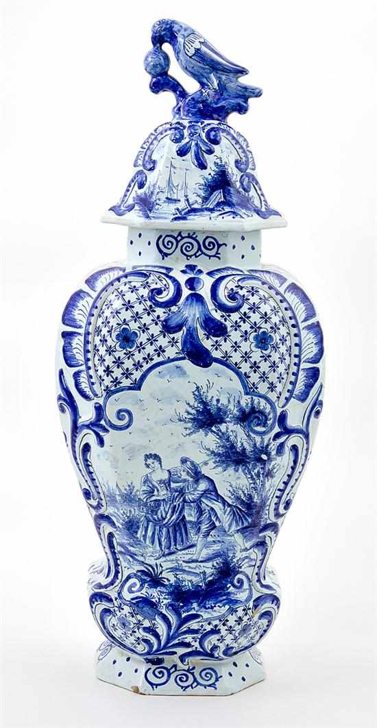 Appraisal: Delft blue and white covered urn th century Baroque-form vessel