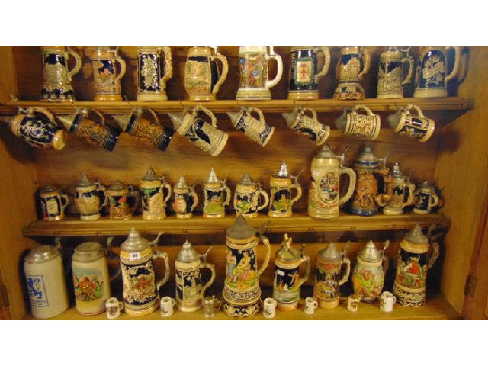 Appraisal: An extensive collection of steins mainly with relief moulded and