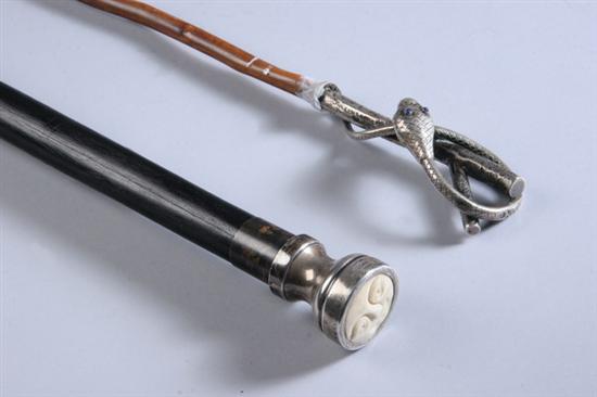 Appraisal: TWO STERLING HANDLED CANES One round sterling handle with carved