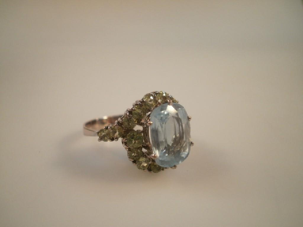 Appraisal: An aquamarine and periodot set cluster dress ring white gold