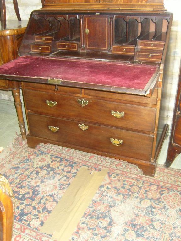 Appraisal: A Georgian mahogany bureau the fall front enclosing fitted stepped