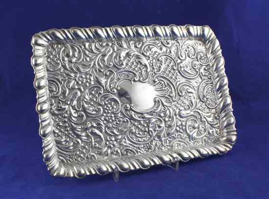 Appraisal: An Edwardian repousse silver dressing table tray decorated with scrolling