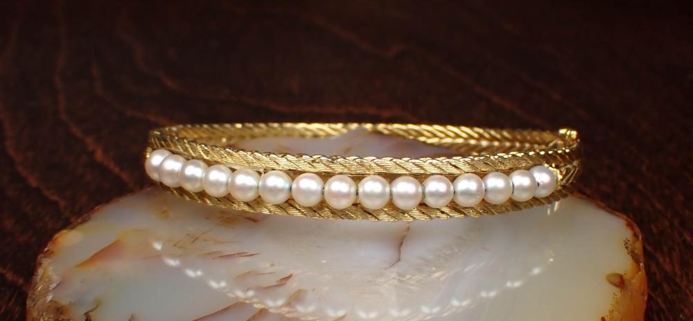 Appraisal: ITALIAN MADE PEARL AND EIGHTEEN KARAT GOLD BANGLE The oval