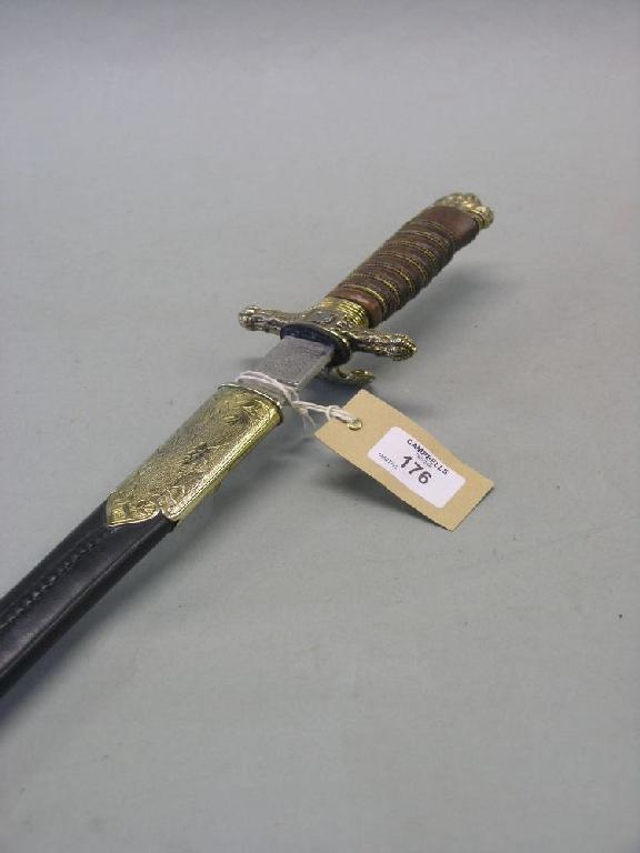 Appraisal: A reproduction German hunting sword in leather scabbard