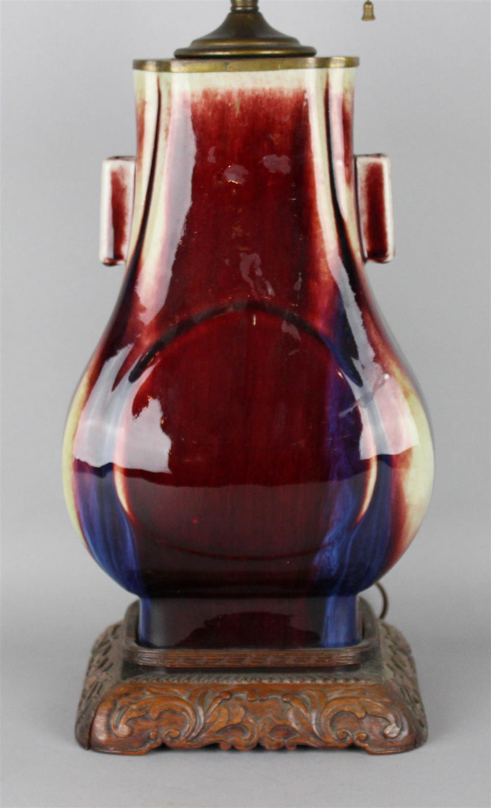 Appraisal: CHINESE SANG-DE-BOEUF-GLAZED VASE QING DYNASTY of hu-form with molded oval