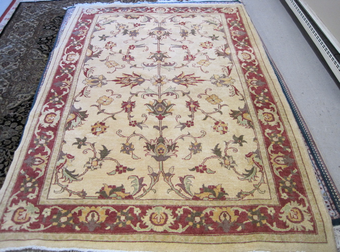 Appraisal: HAND KNOTTED AFGHANI CARPET overall scrolling vine decoration on khaki