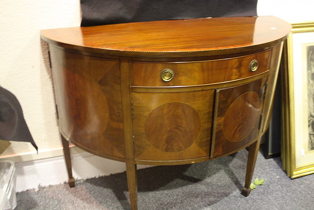 Appraisal: AN EDWARDIAN MAHOGANY AND INLAID DEMI-LUNE SIDEBOARD the top having