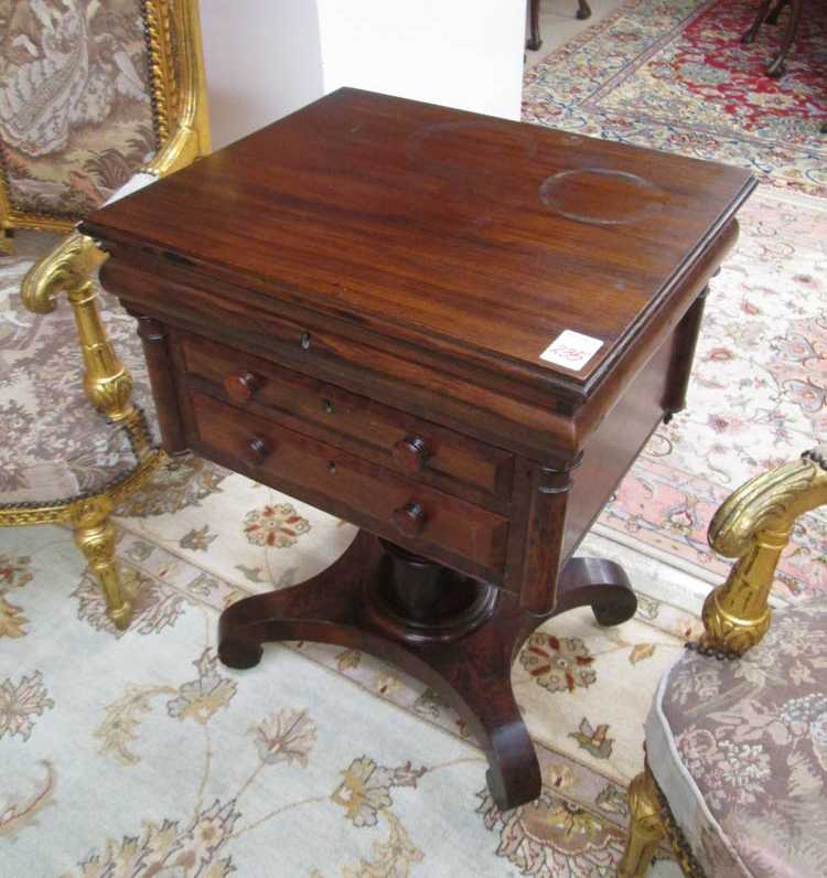 Appraisal: AN EMPIRE MAHOGANY LIFT-TOP WORK TABLE Pillar Scroll substyle American