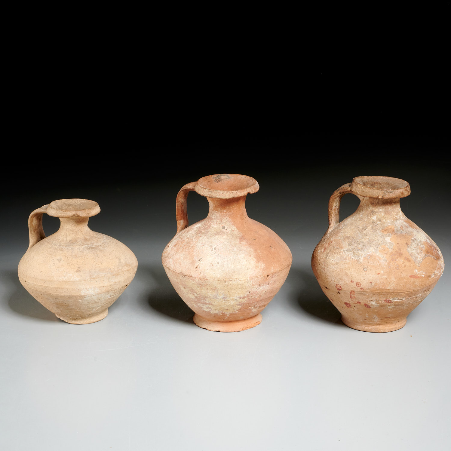 Appraisal: ROMAN STYLE EARTHENWARE JUGS EX-MUSEUM Poss c BCE- CE unglazed