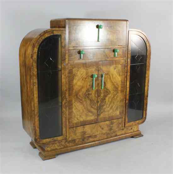 Appraisal: An Art Deco figured walnut cocktail display cabinet with stylish