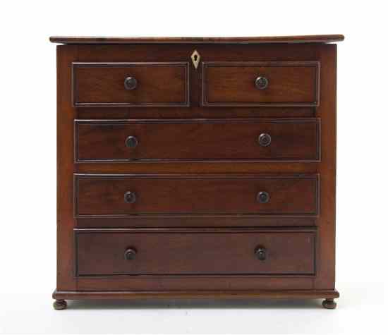 Appraisal: A Diminutive Mahogany Chest of Drawers having a hinged rectangular