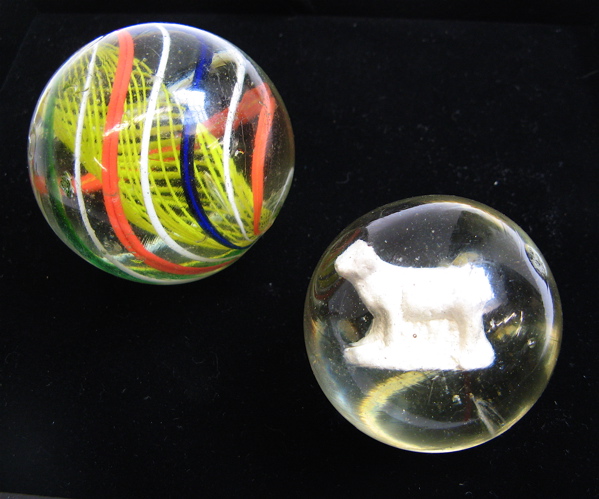 Appraisal: TWO BOWLER GLASS MARBLES the larger - D clear with