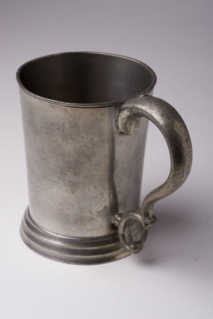 Appraisal: PEWTER HANDLED BEAKER ATTRIBUTED TO NELSON HALL AND FREDERICK COTTON